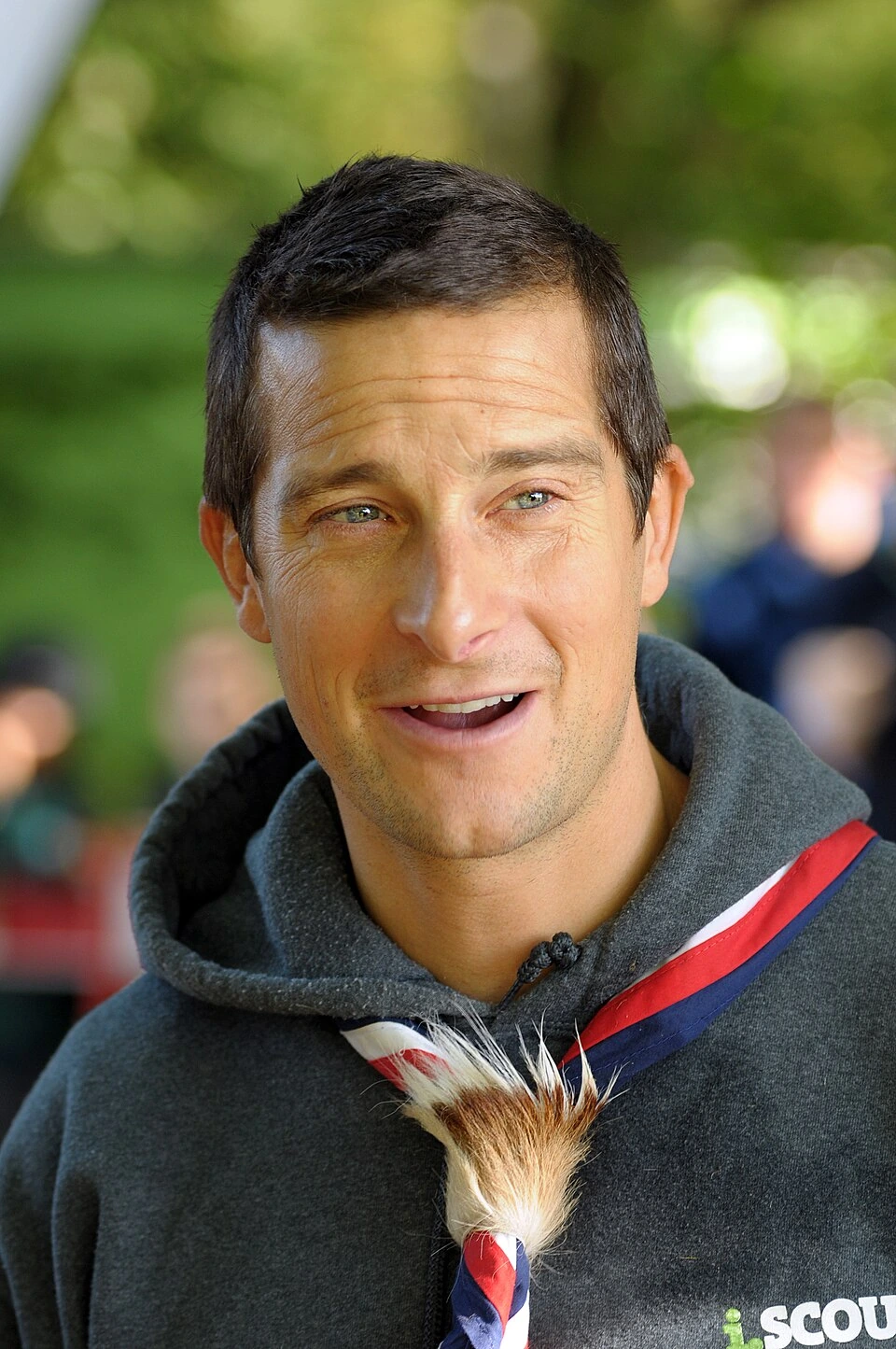 Bear Grylls speaking outdoors at a Scouts event