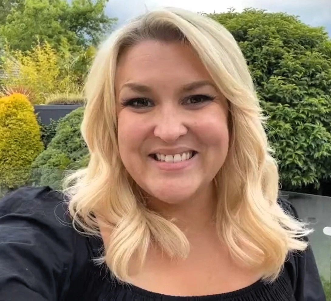 Sara Davies smiling outdoors in a candid photo