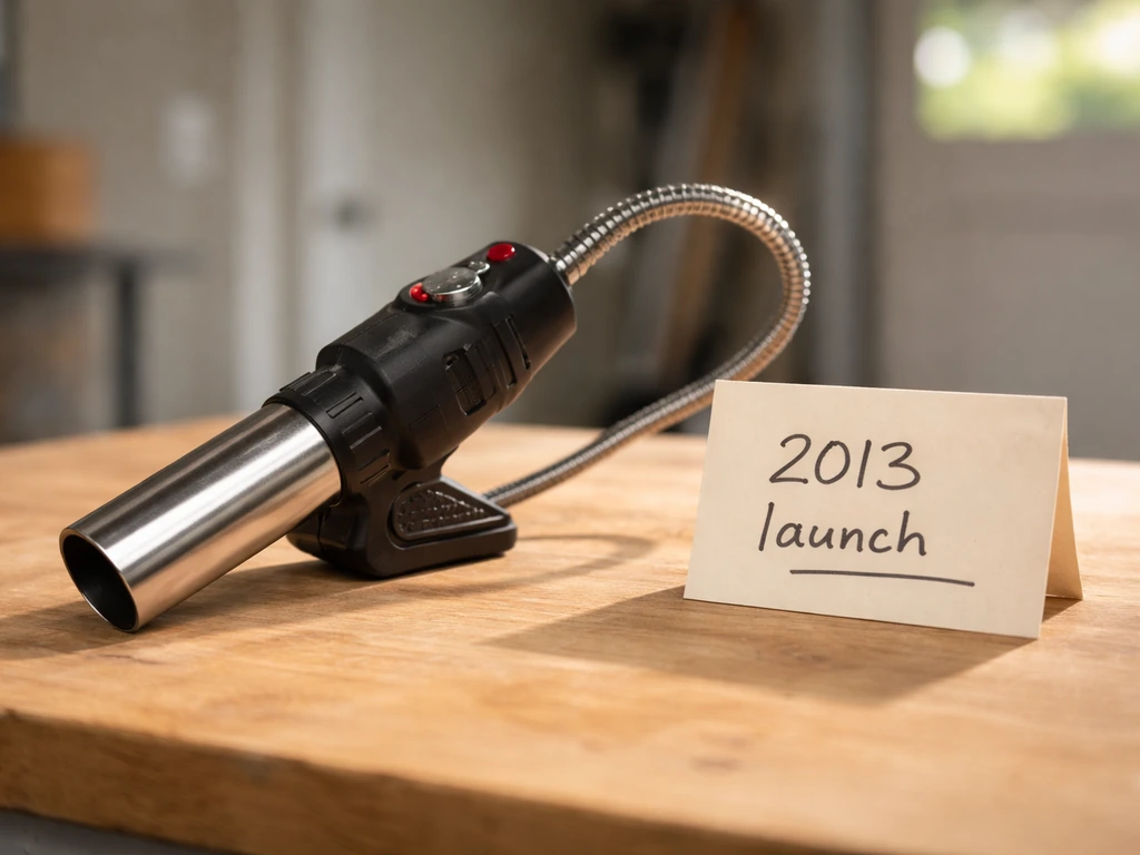 2013-style BBQ Dragon Fan on a simple table with a handwritten 2013 launch card beside it.