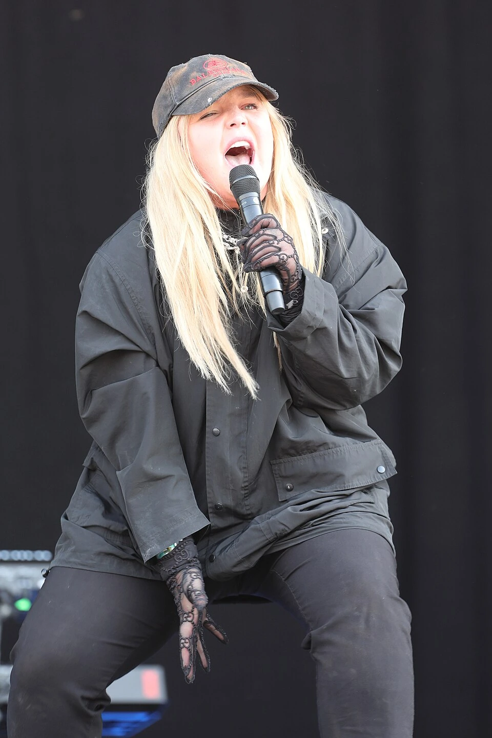 Tones and I performing on stage at Southside Festival 2022, singing into a microphone