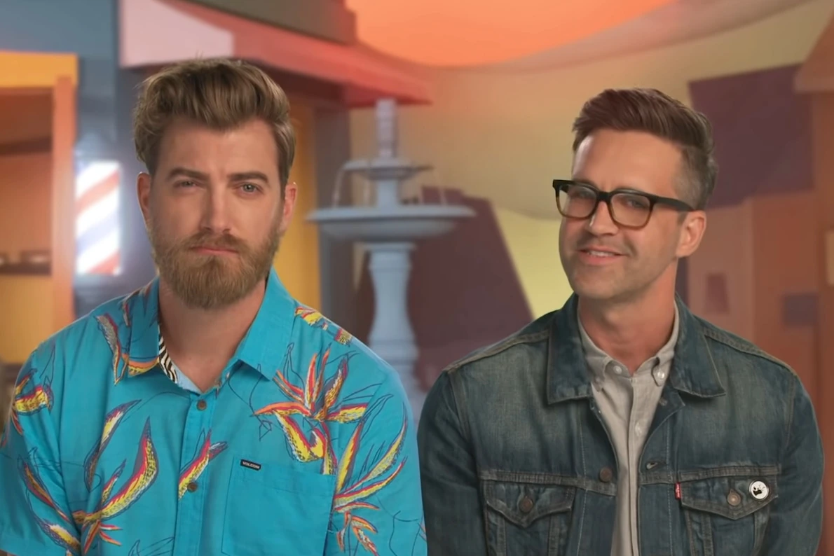 Rhett and Link posing together in a studio setting
